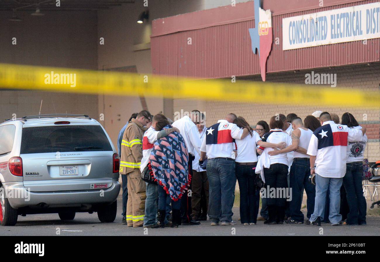 Parade participants and public safety officials huddle after a trailer carrying wounded veterans in a parade was struck by a train in Midland, Texas, Thursday, Nov. 15, 2012. Authorities say four people are dead and 17 others are injured after a Union Pacific train slammed into the parade float. (AP Photo/Reporter-Telegram, James Durbin) Stock Photo