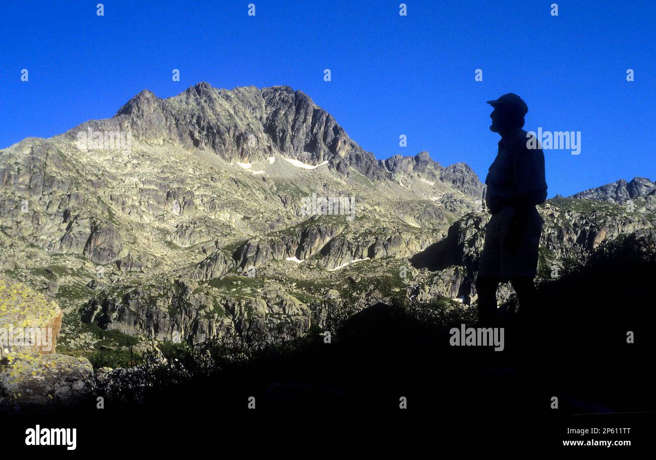 Tripper near to the lake Obago,Colomèrs cirque,Aran Valley, Aigüestortes and Estany de Sant Maurici National Park,Pyrenees, Lleida province, Catalonia Stock Photo