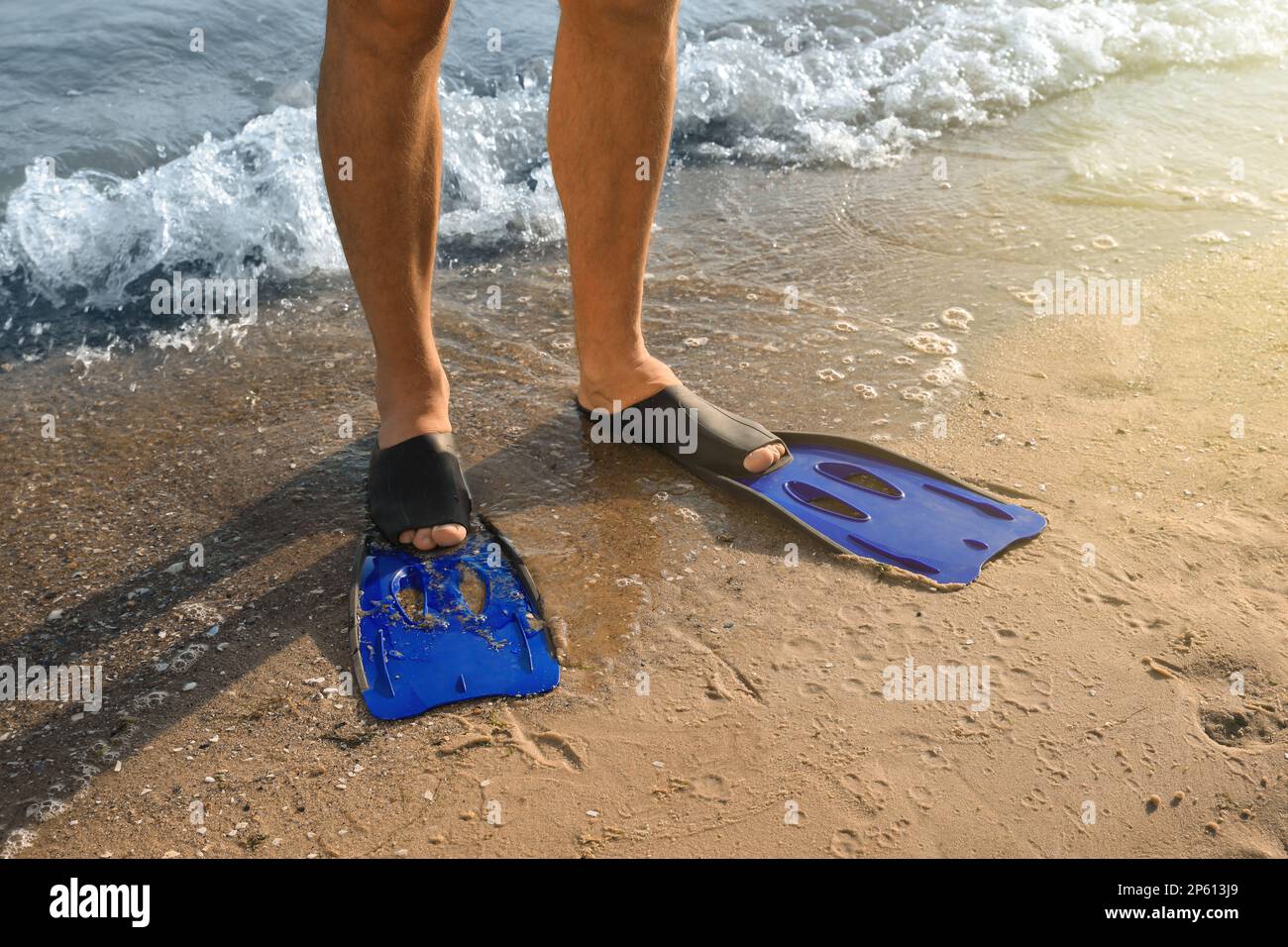 Man in flippers on sandy beach, closeup Stock Photo - Alamy