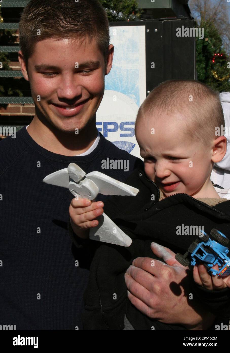 David Collas, 18, holds 3-year-old Ashton King after toys were 