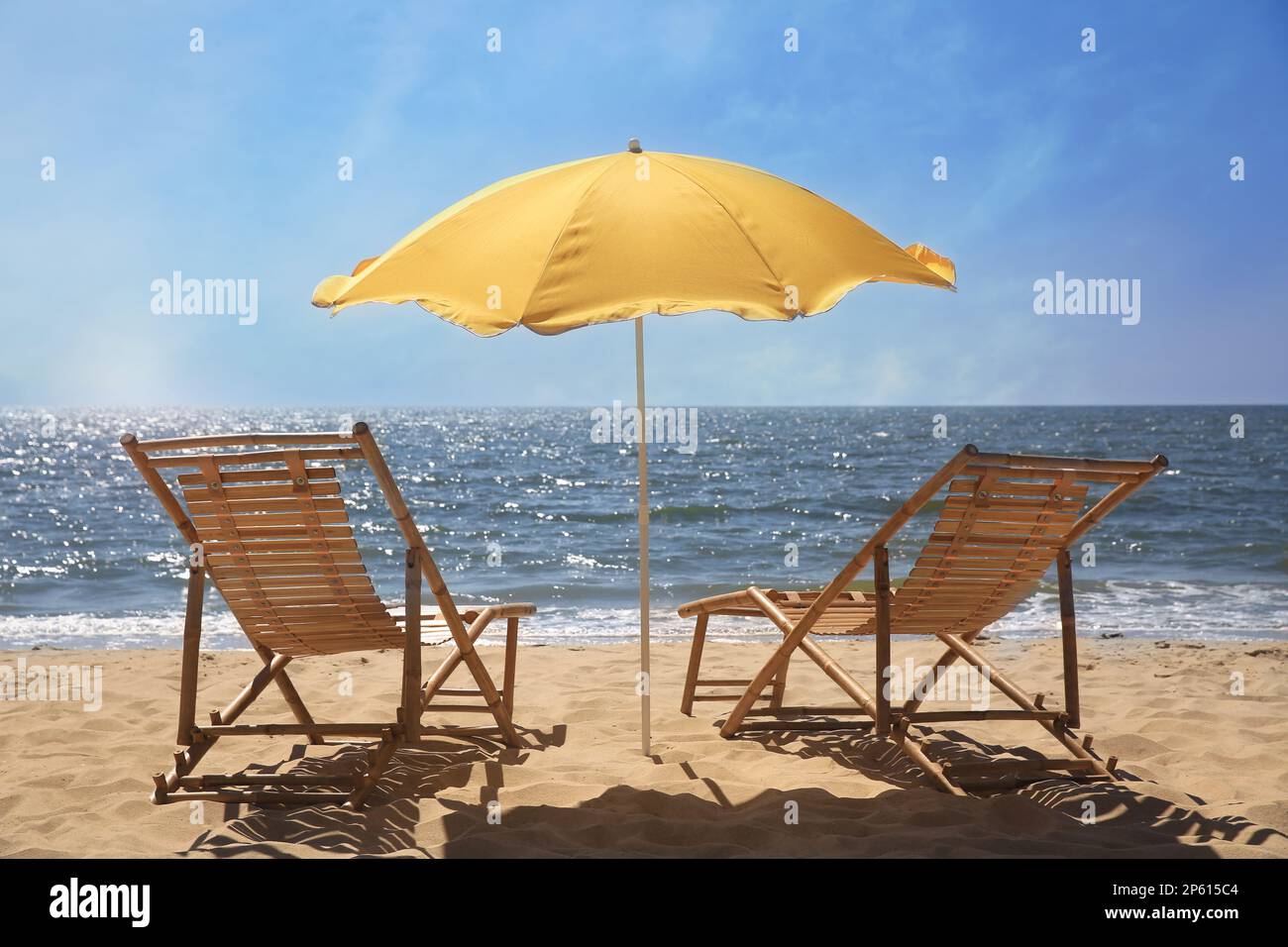 Orange beach umbrella and deck chairs on sandy seashore Stock Photo Alamy
