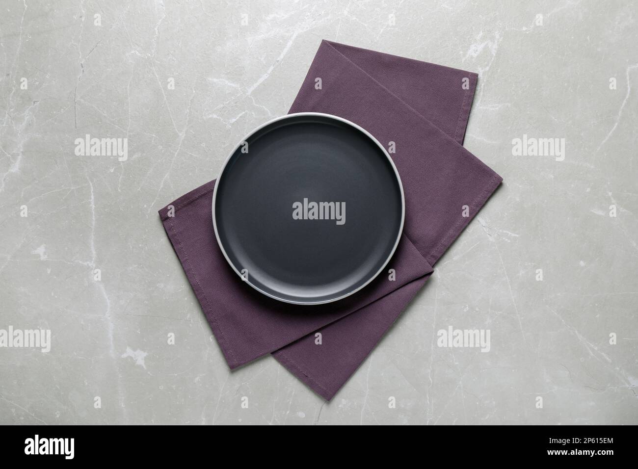 New dark plate and napkin on light grey table, top view Stock Photo Alamy