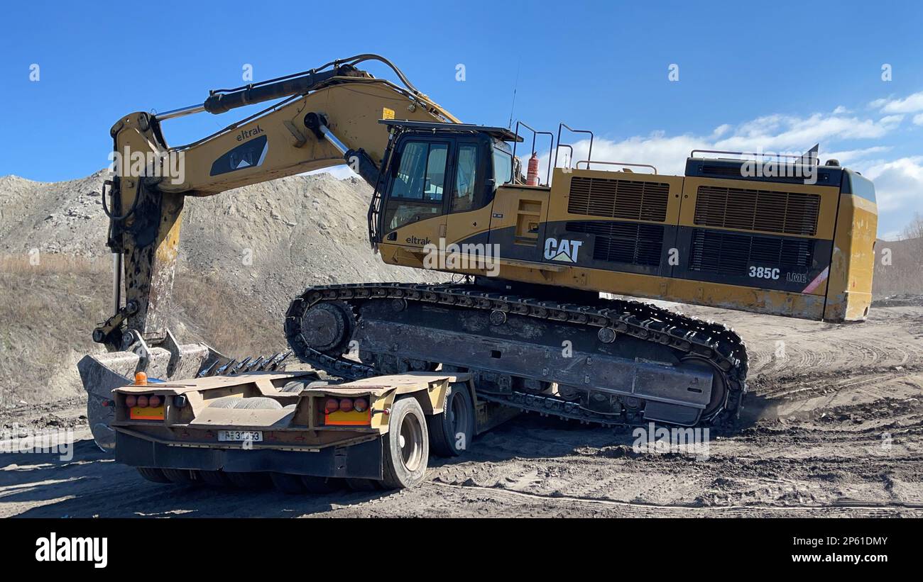 Transporting the excavator to the mining site, heavy transport Stock ...