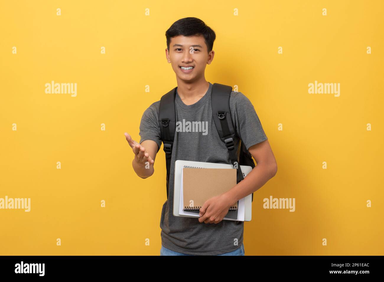 Smiling young college student with books and backpack isolated on ...