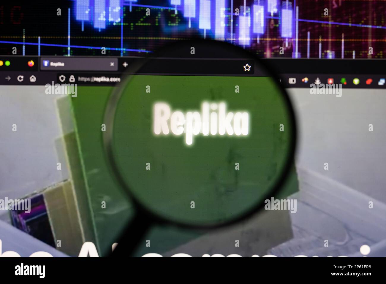 Replika chatbot company logo on a website with blurry stock market developments in the background, seen on a screen through a magnifying glass Stock Photo