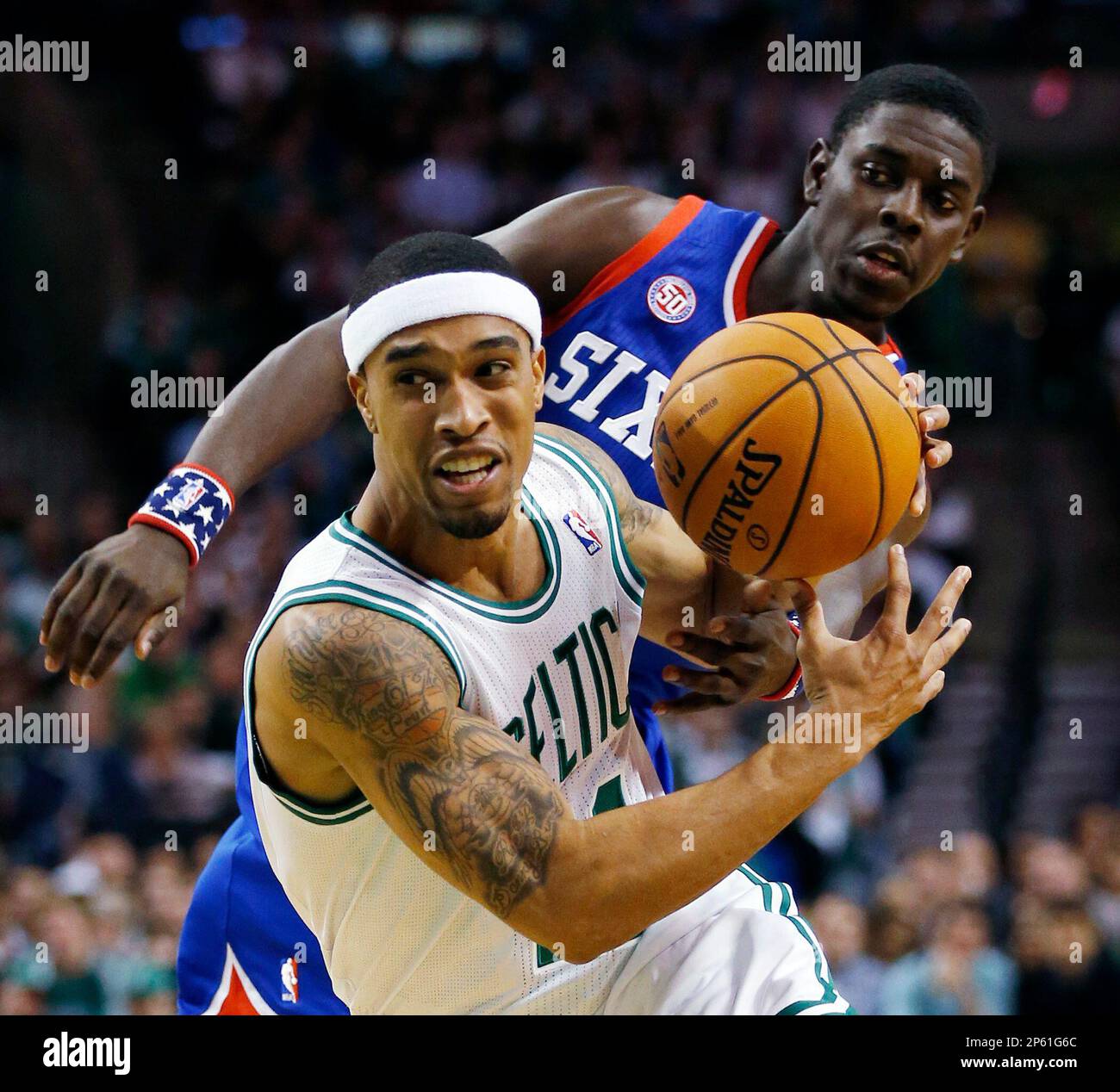 Boston Celtics' Courtney Lee, left loses control of the ball to Philadelphia 76ers' Jrue Holiday