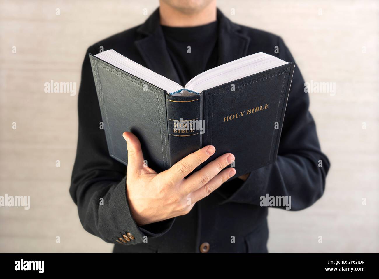 Close-up of Christian man hands while reading the Bible outside.Sunday readings, Bible education. spirituality and religion concept. Reading a book. Stock Photo