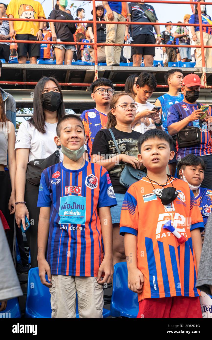Crowd standing for national anthem at Thai football match, Bangkok