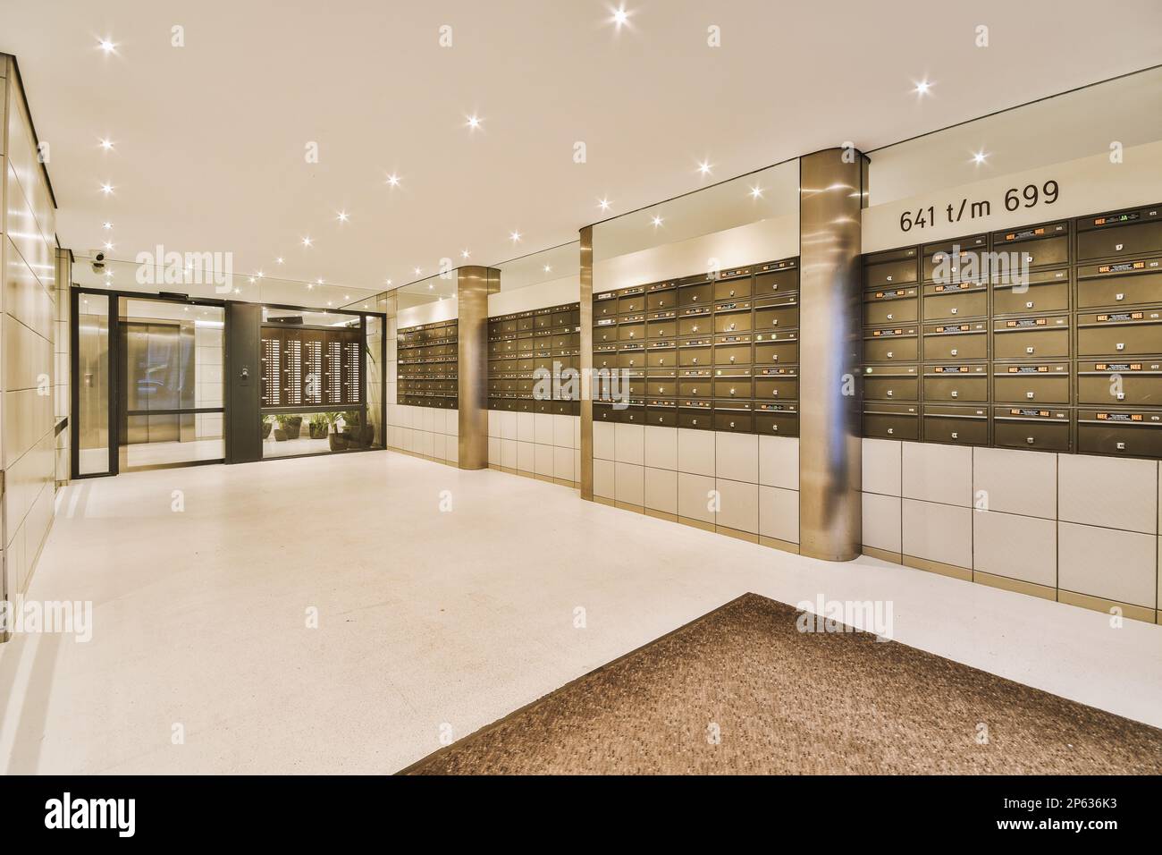 a large room with many mail boxes on the wall and an open door leading ...