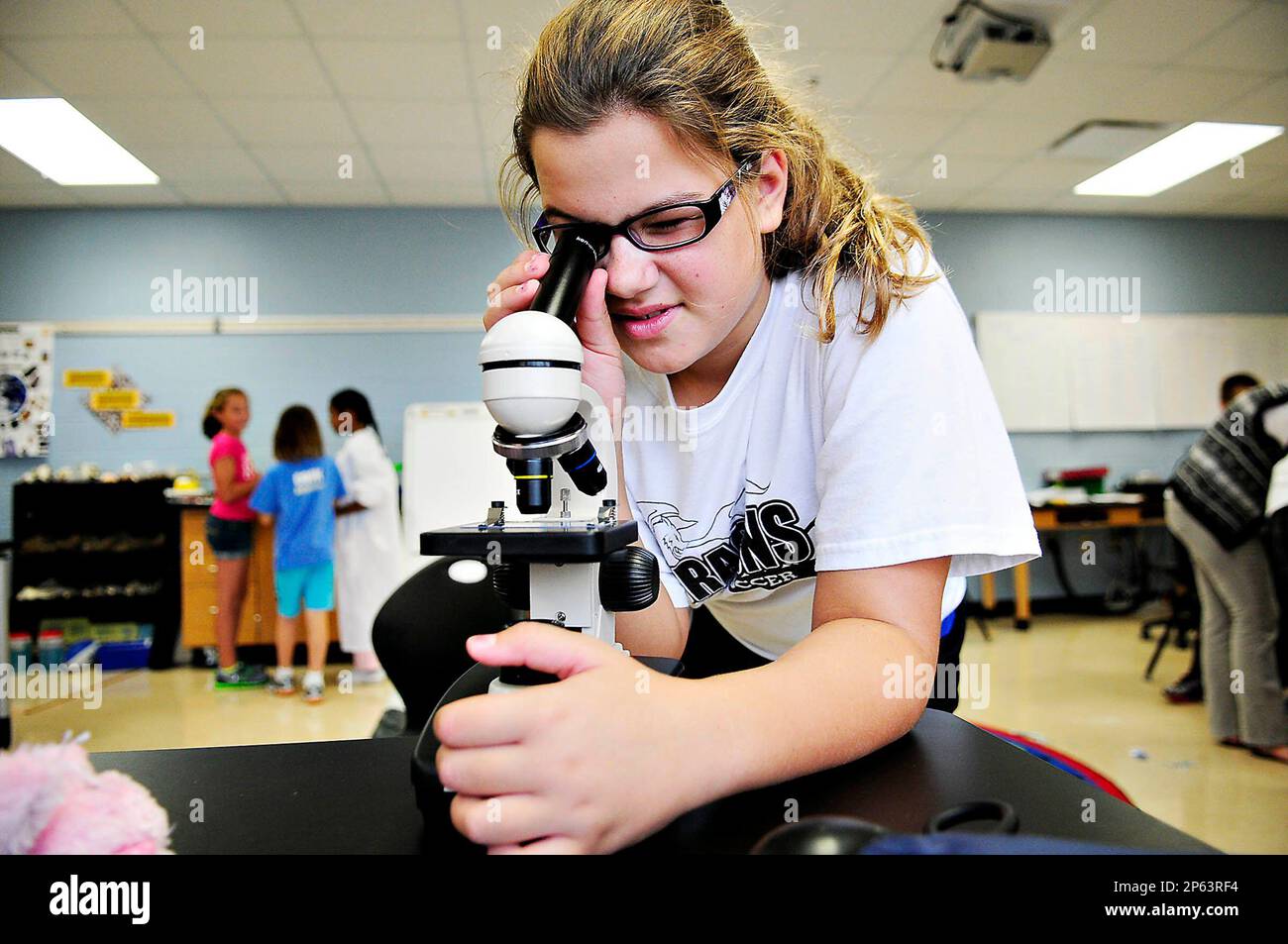ADVANCE FOR SUNDAY OCT. 14 - In this Sept. 26, 2012 photo, Ella Alic, 10,  from Lost River Elementary School examines a slide through a microscope at  the Warren County School's Gifted