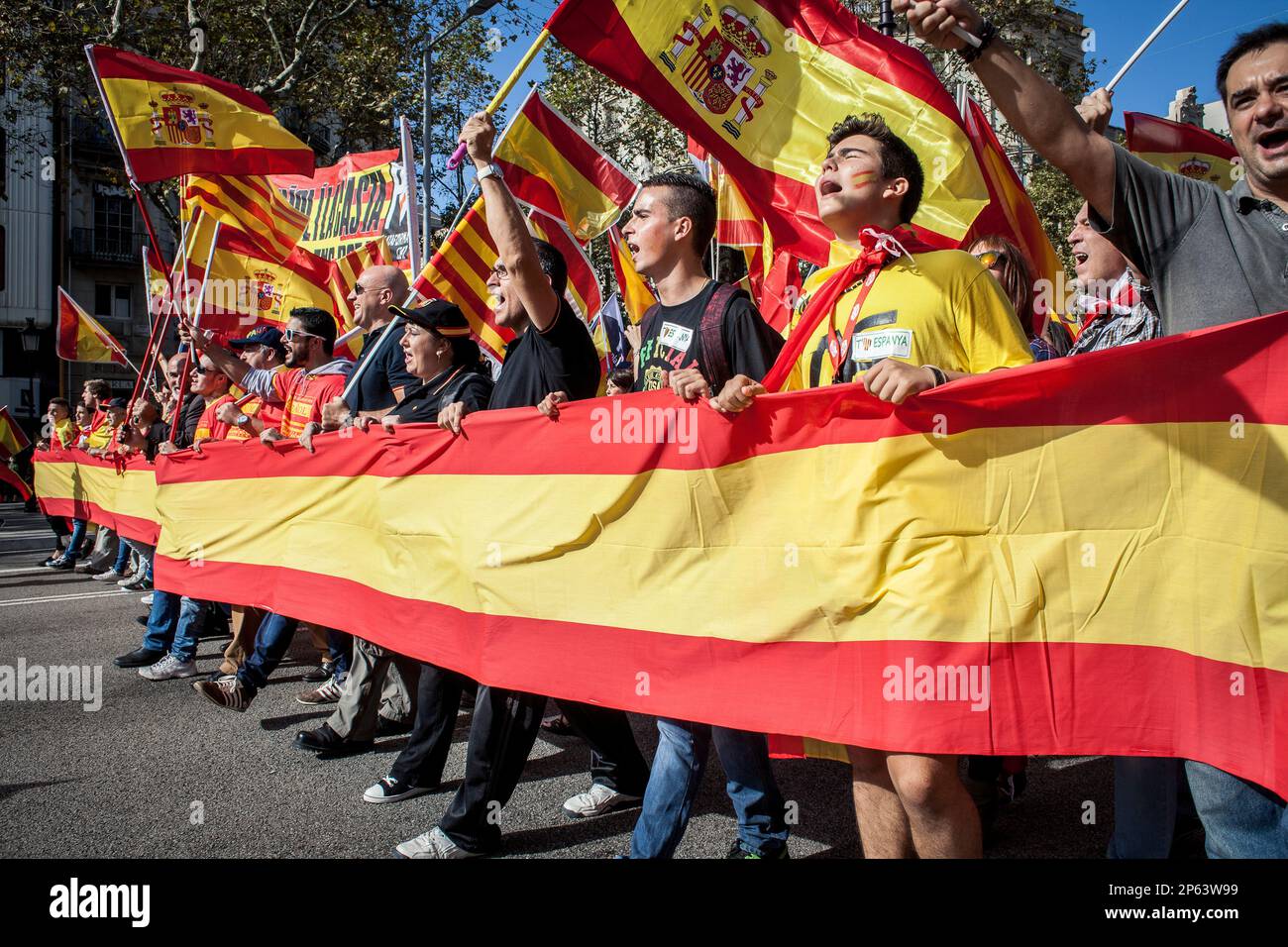 Anti-independence Catalan protestors carry Spanish and catalan flag during  a demonstration for the unity of Spain on the occasion of the Spanish Natio  Stock Photo - Alamy