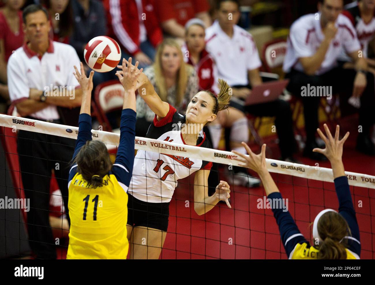 Nebraskas Hayley Thramer spikes the ball as Michigans Lexi Erwin goes for the block during a NCAA volleyball game Sunday Sept. 30, 2012 in Lincoln, Neb