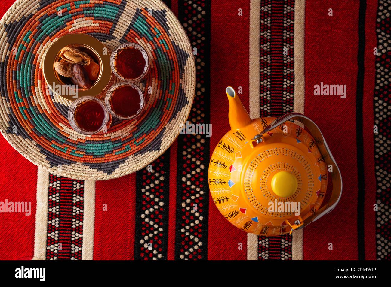 Iconic Arabian fabric is graced with symbols of Arabia, in particular Arabic tea and dates, they symbolise Arabian hospitality, ramadan set Traditiona Stock Photo
