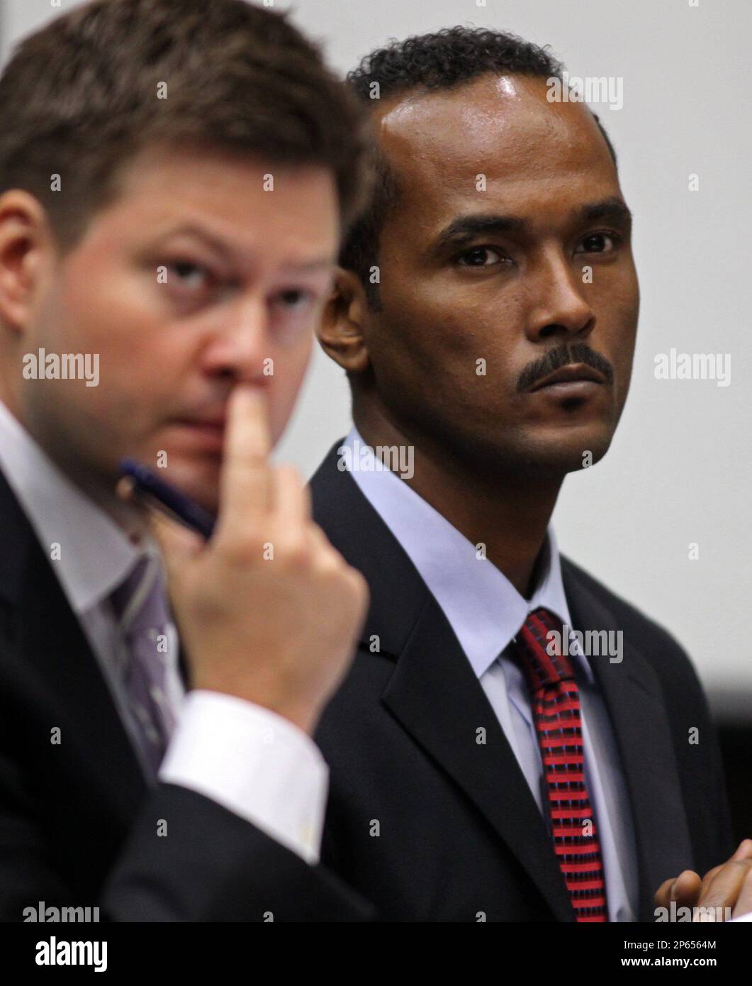 Reginald Clemons, right, and his attorney Andrew Clay listen to