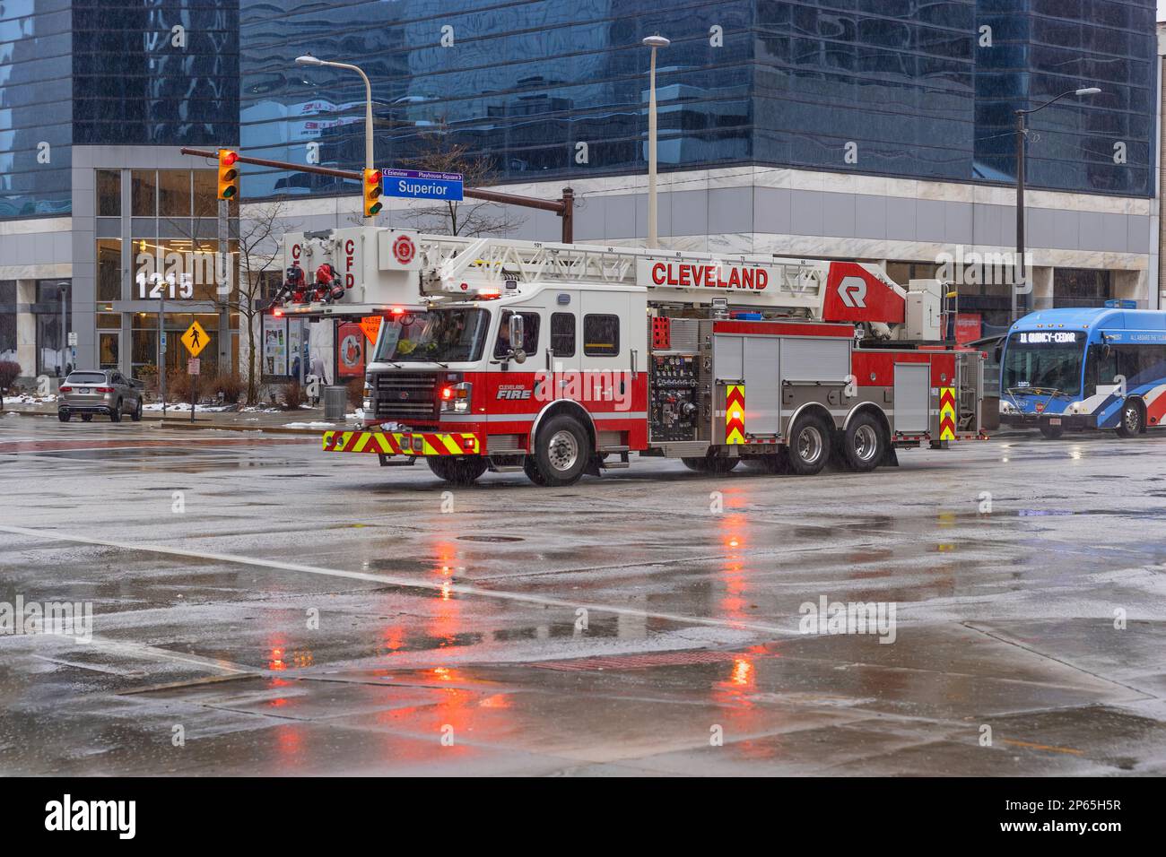 Cleveland, Ohio, USA - January 25, 2023: A fire truck crossing an intersection on an emergency call in downtown district. Stock Photo