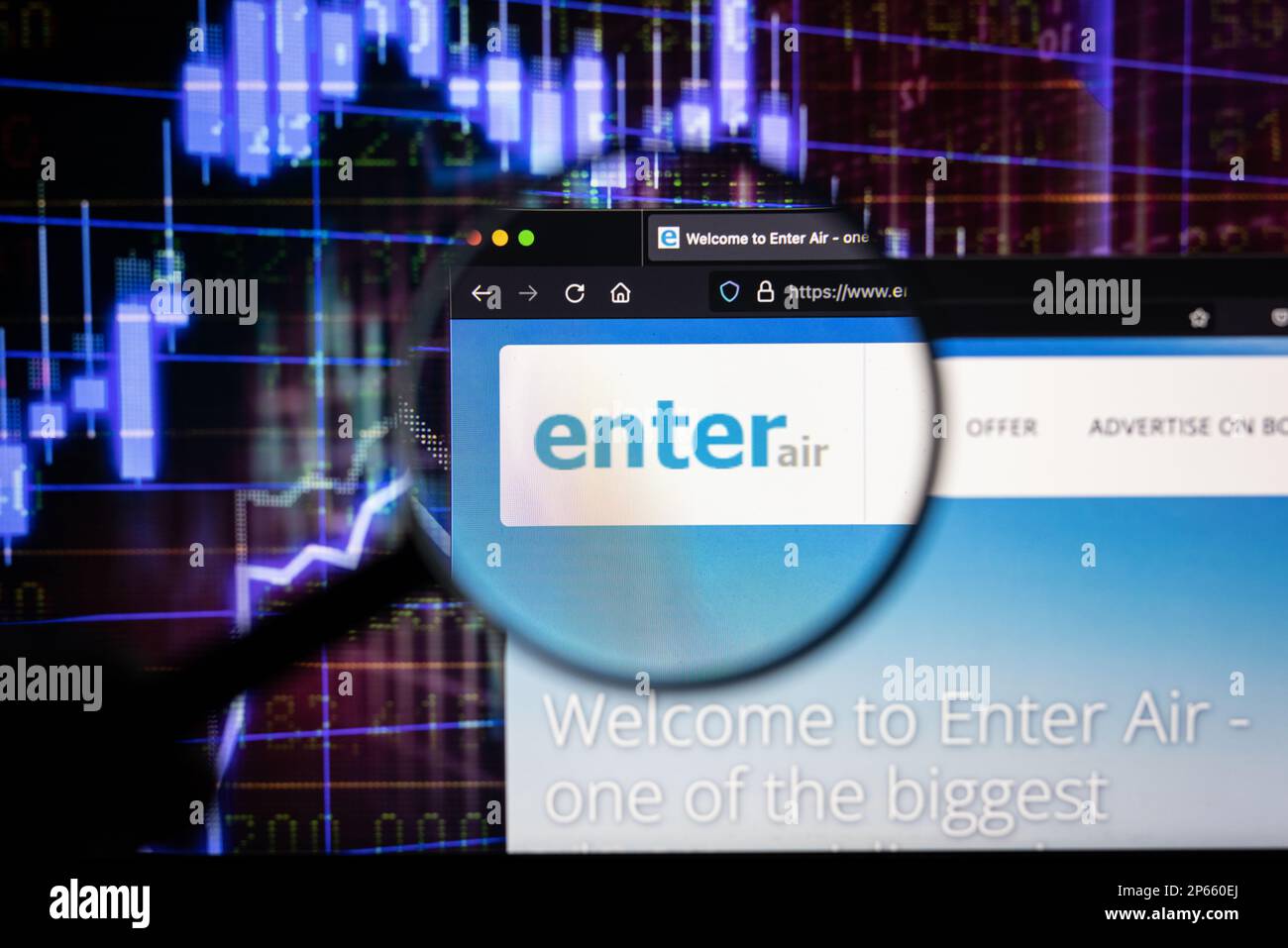 Enter Air company logo on a website with blurry stock market developments in the background, seen on a computer screen through a magnifying glass Stock Photo