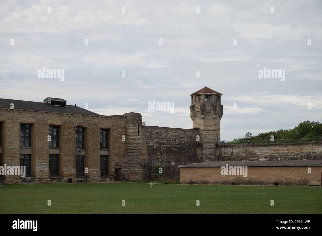 The facade of the historic Joliet Prison against a cloudy sky Stock Photo