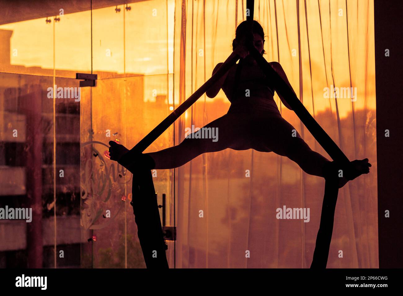 A Colombian aerial dancer performs on aerial silks during a training session in the Oshana gym in Barranquilla, Colombia. Stock Photo