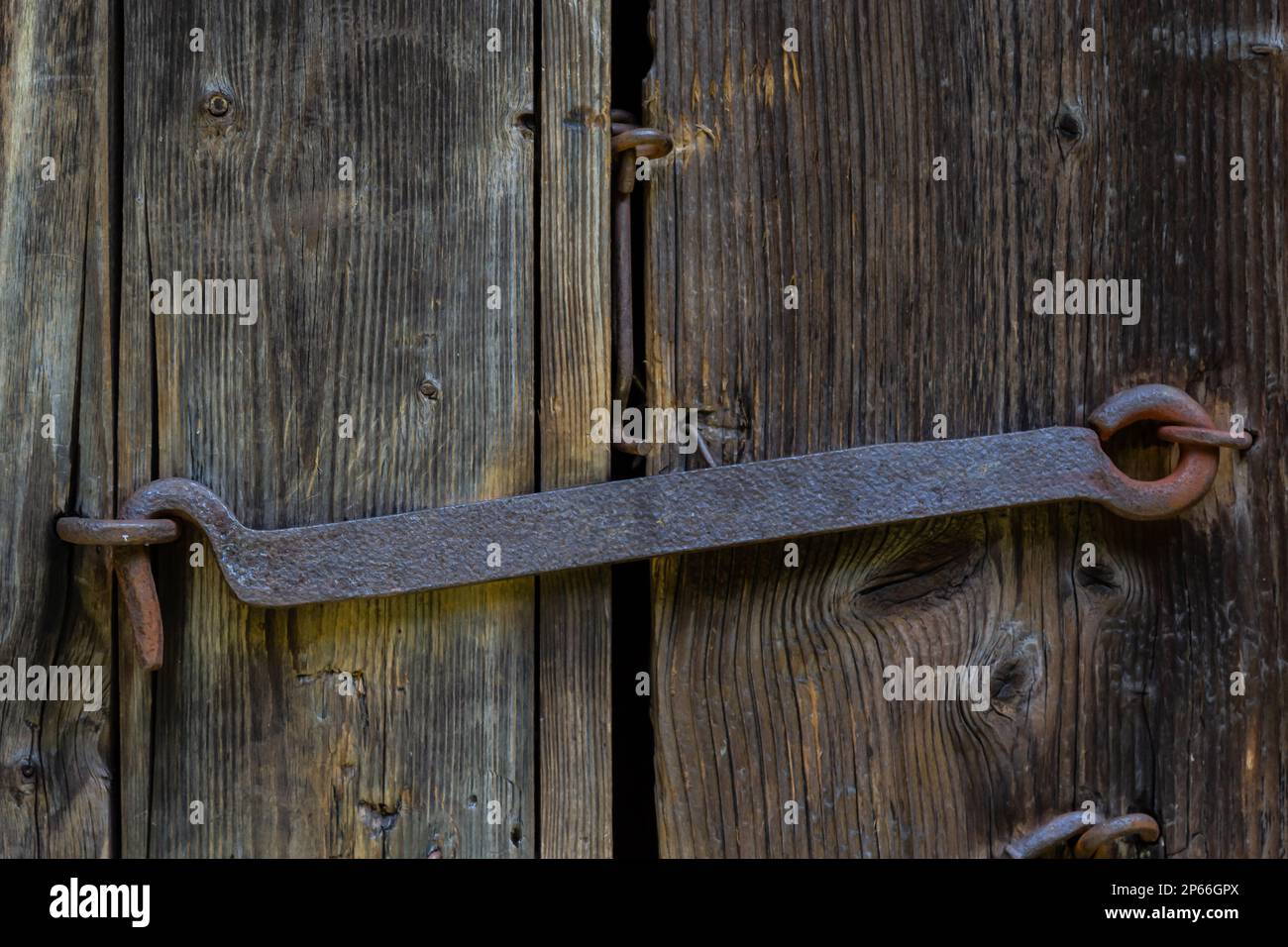 Old rusty lock on the wooden door, background. Stock Photo
