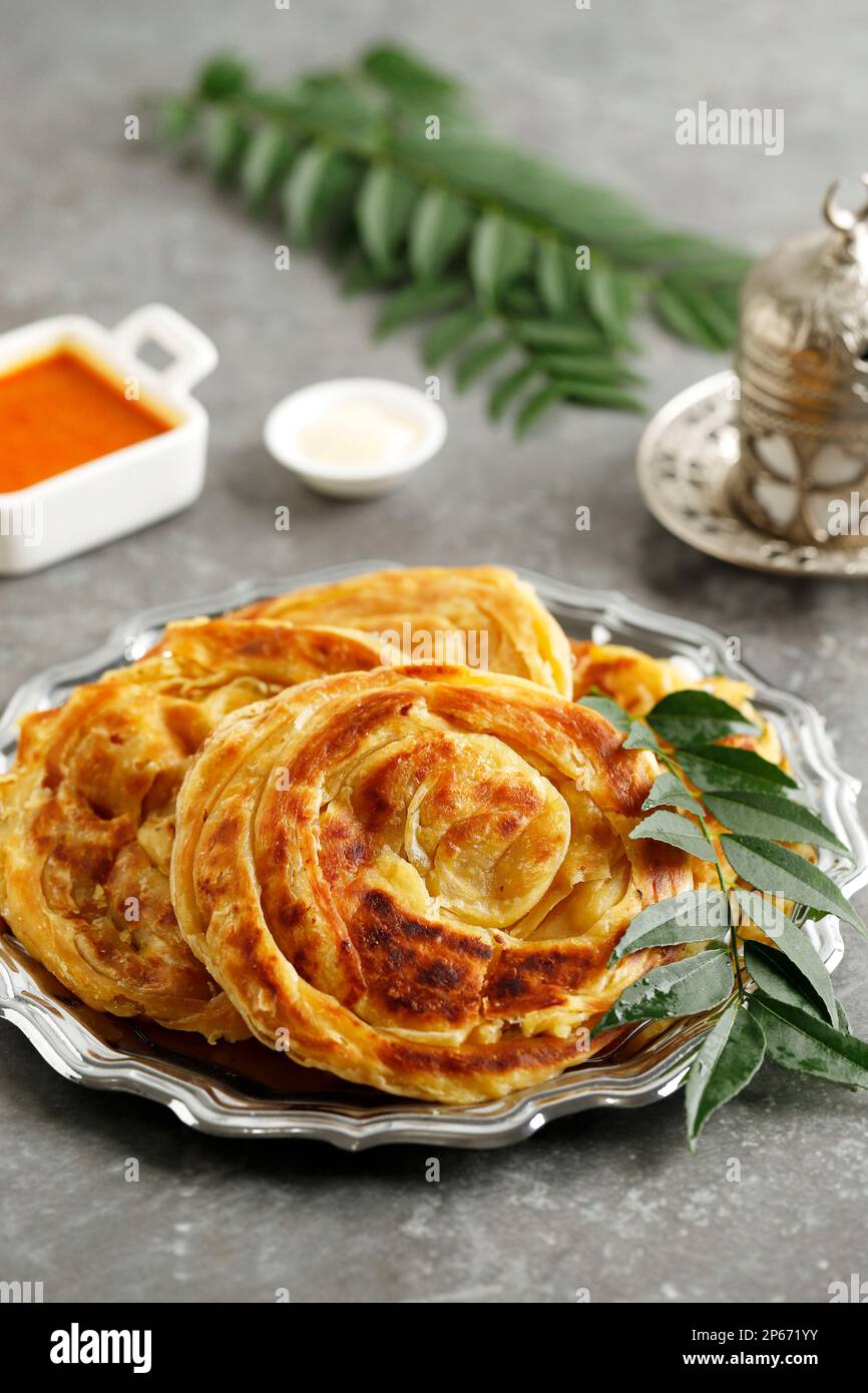 Roti Parata or Roti Canai with Chicken Curry Sauce, Popular Dish in
