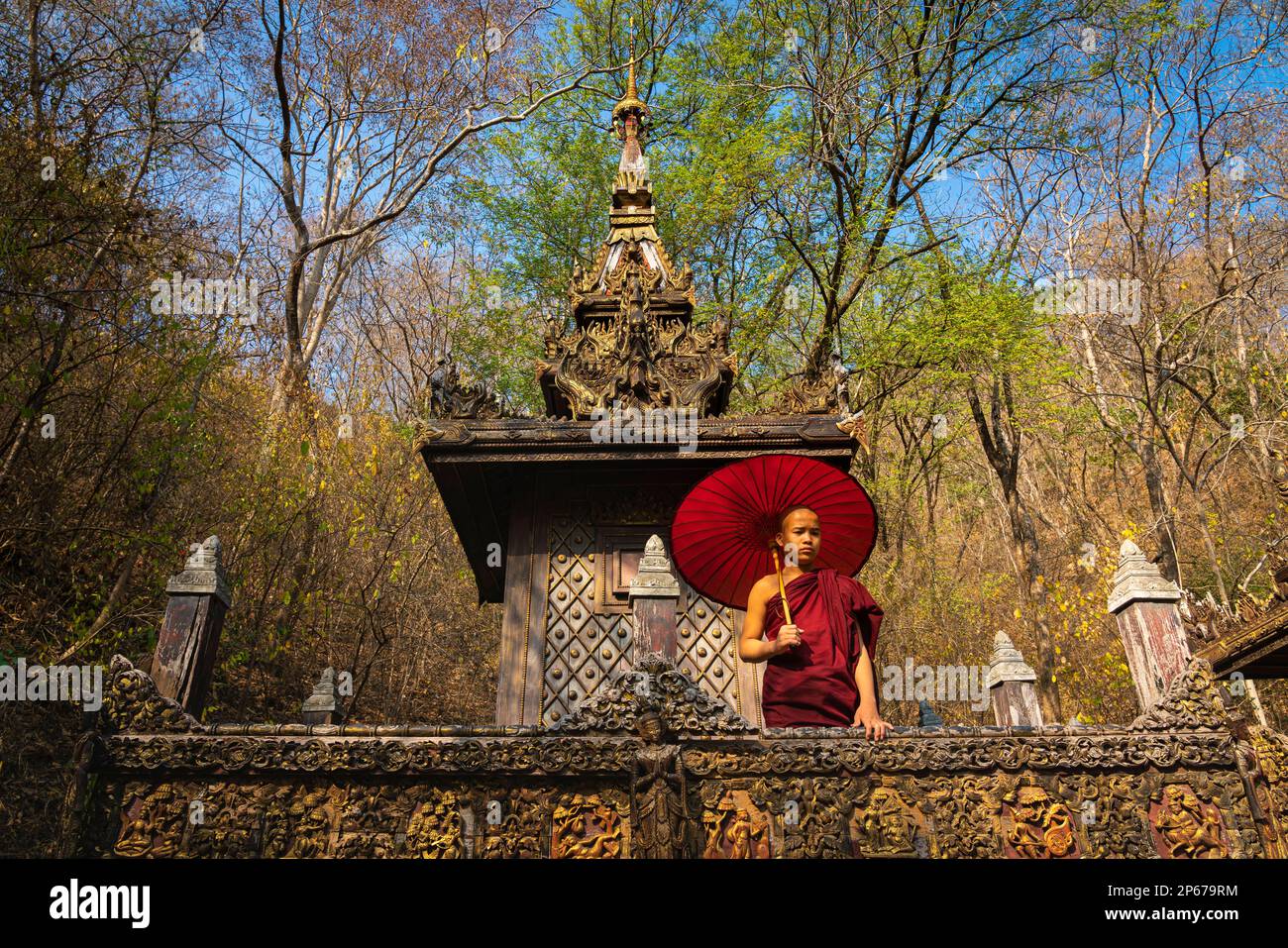 Novice monk with umbrella at monastery, Mandalay, Myanmar (Burma), Asia Stock Photo