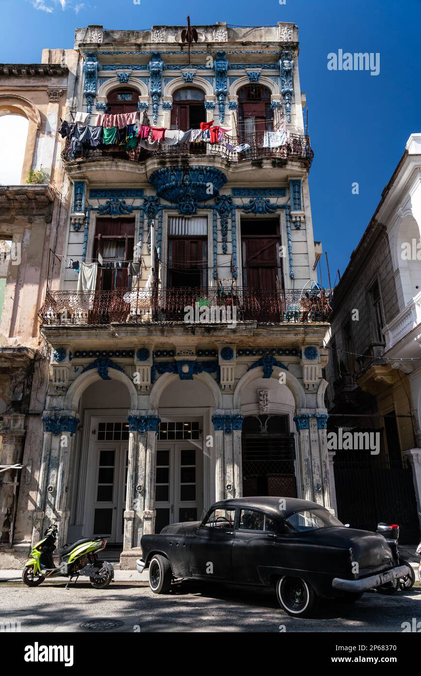 Typical crumbling former mansion, classic car parked outside, in ...