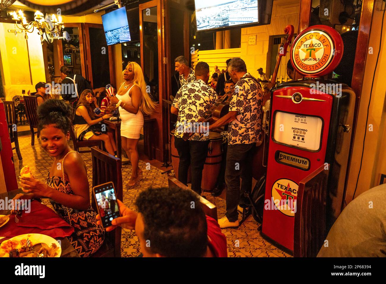 Salsa band and singer playing in retro restaurant, Old Havana, Cuba