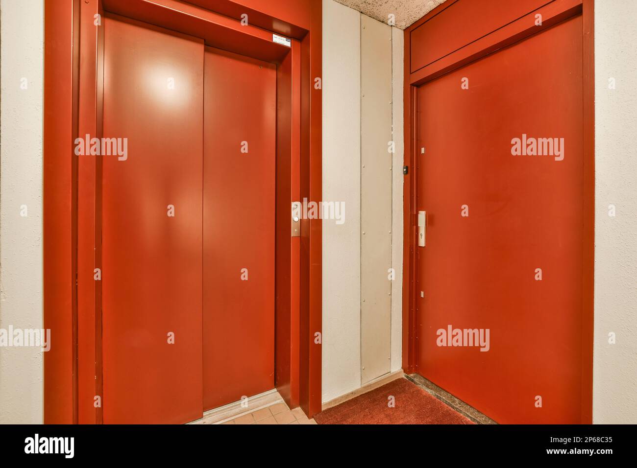 two red doors in an office building, one is open and the other is