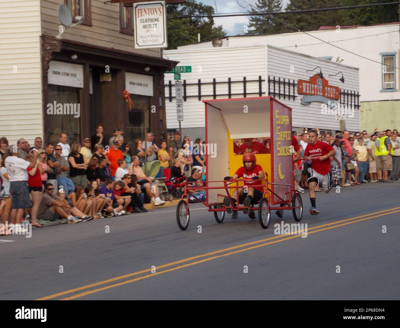 The "Super Septic Suckers" outhouse makes its way down the street on