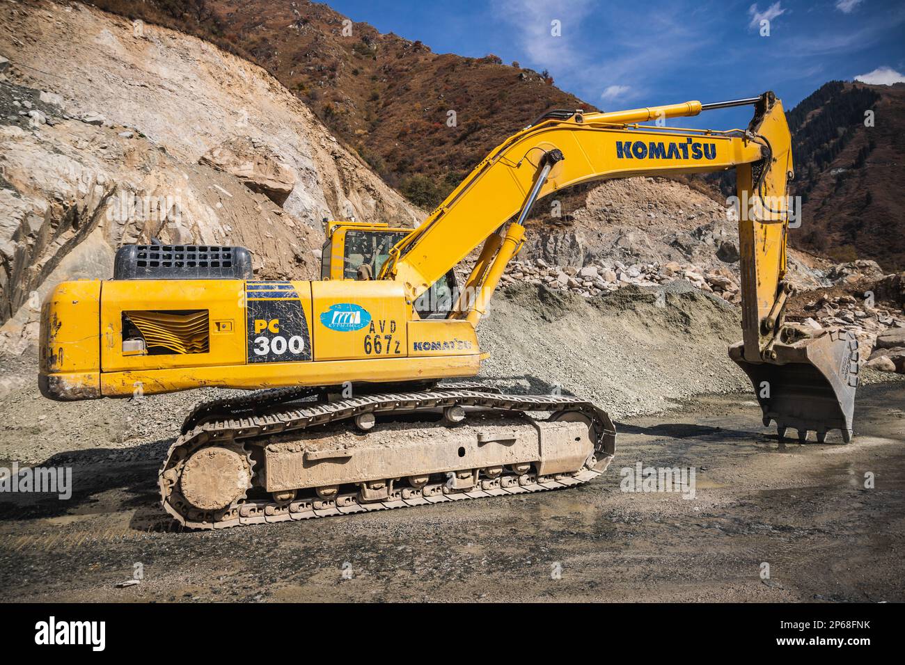 Komatsu PC300 yellow excavator in Almaty mountains involved