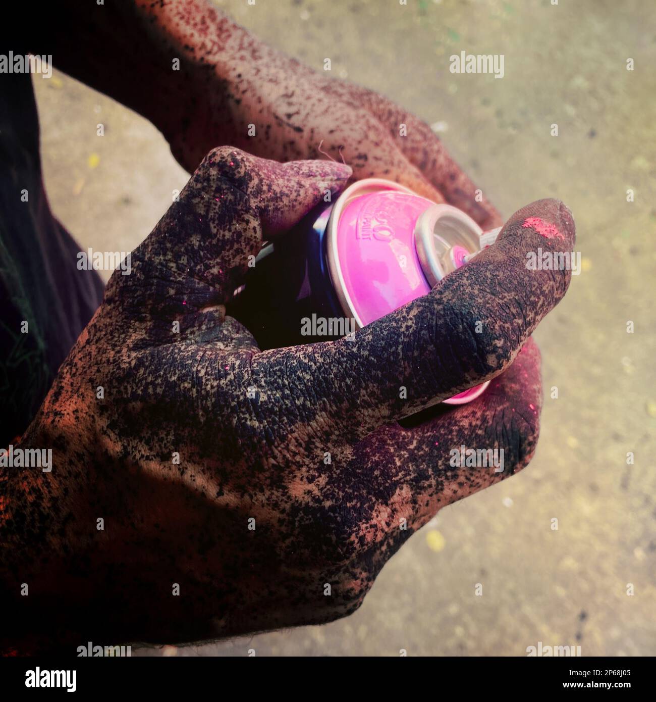 A Mexican street artist, having his hand splashed with black paint