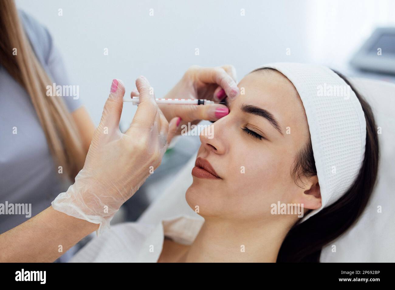 Beauty injections. Female cosmetologist in transparent gloves makes an