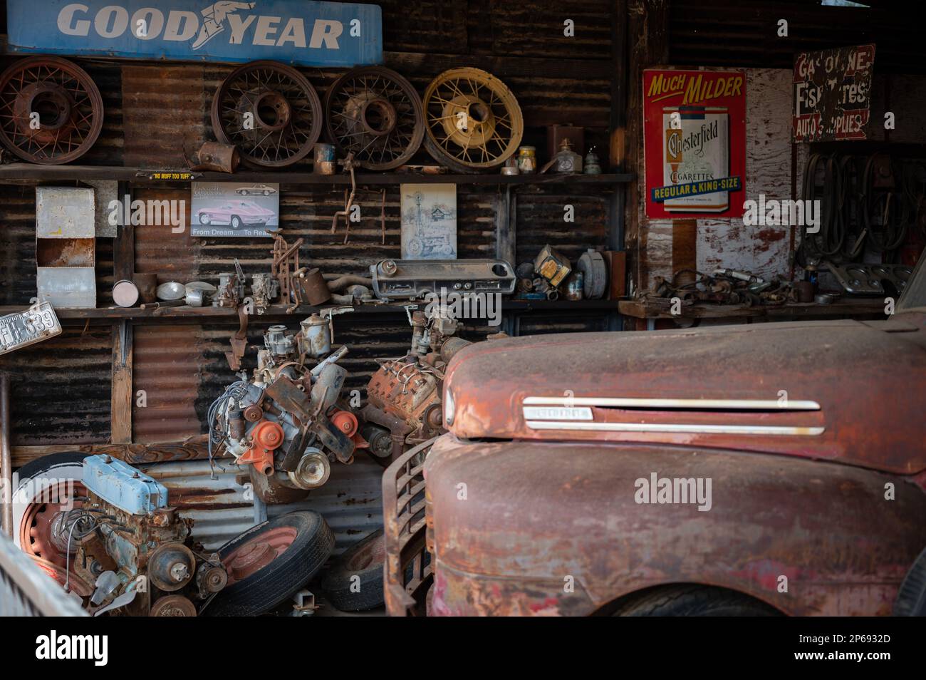 Old abandoned car mechanic shop on the desert road. Inside is an old Ford F-1 pickup. Stock Photo