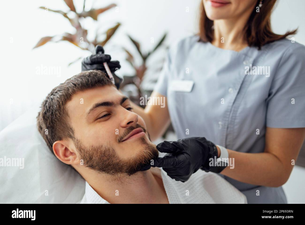 Beauty injections. Female cosmetologist in transparent gloves makes an