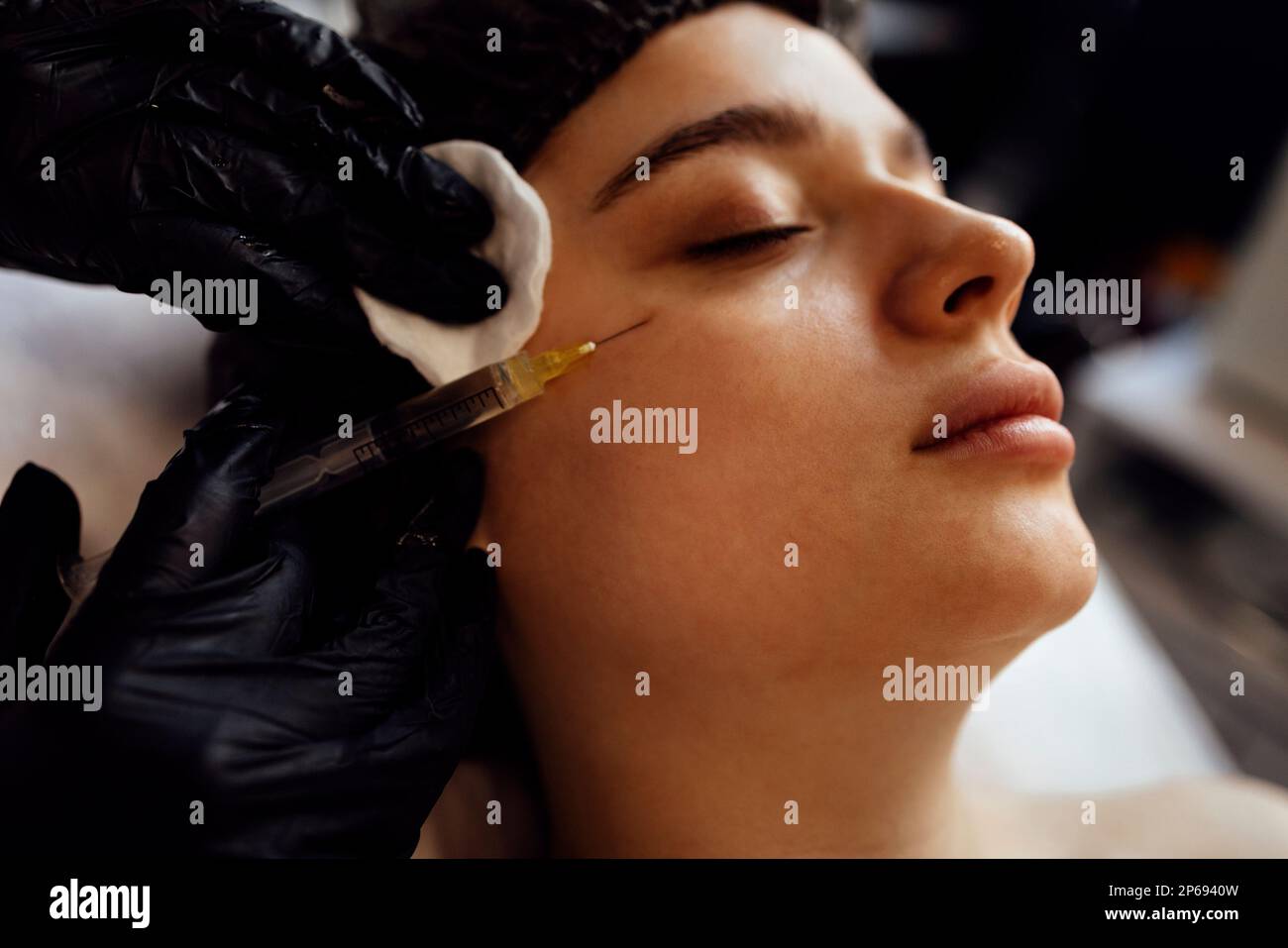 Beauty injections. Female cosmetologist in transparent gloves makes an