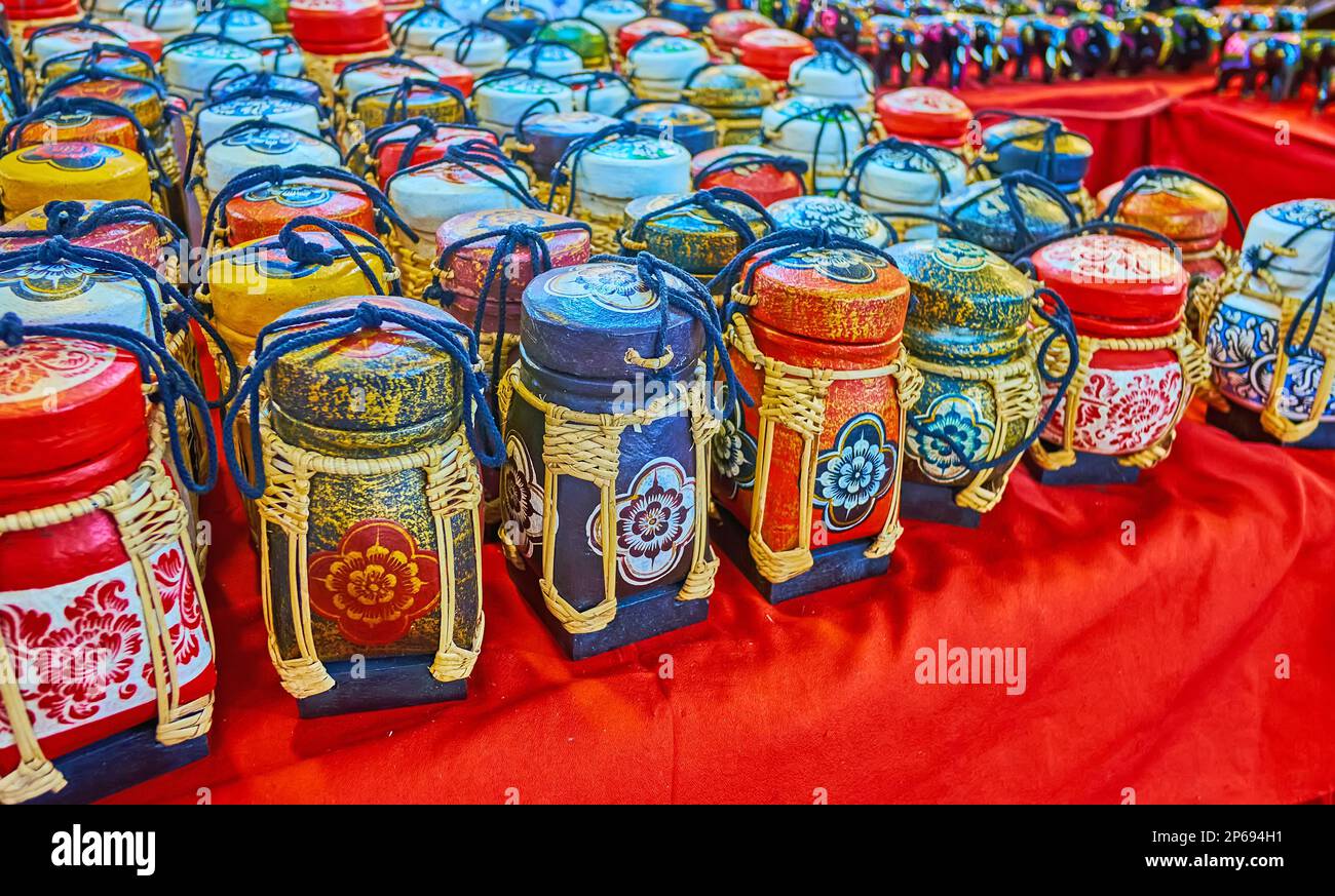 Handmade bamboo rice boxes, covered with colored floral patterns, Anusarn Night Market, Chiang Mai, Thailand Stock Photo