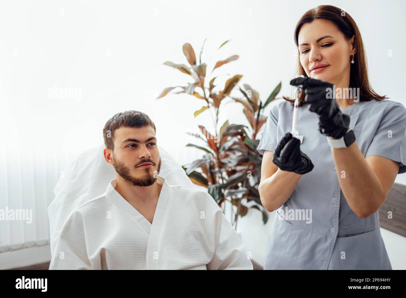 Beauty injections. Female cosmetologist in transparent gloves makes an