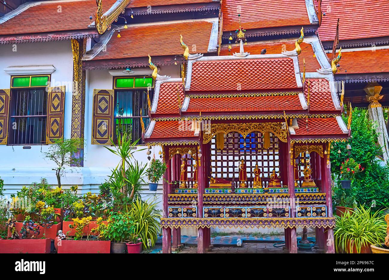 The small stilt shrine with tiny Buddha Images and pyathat roof, Wat Ket Karam, Chiang Mai, Thailand Stock Photo