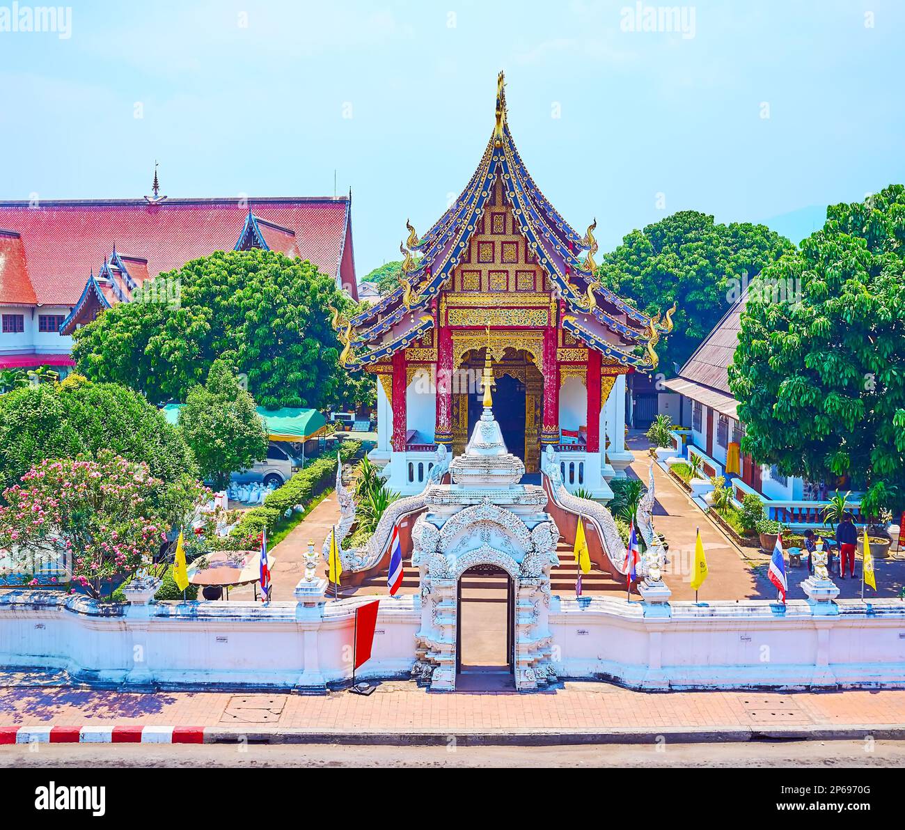 The medieval Lanna style Wat Chang Taem temple, surrounded with flowering garden, Chiang Mai, Thailand Stock Photo