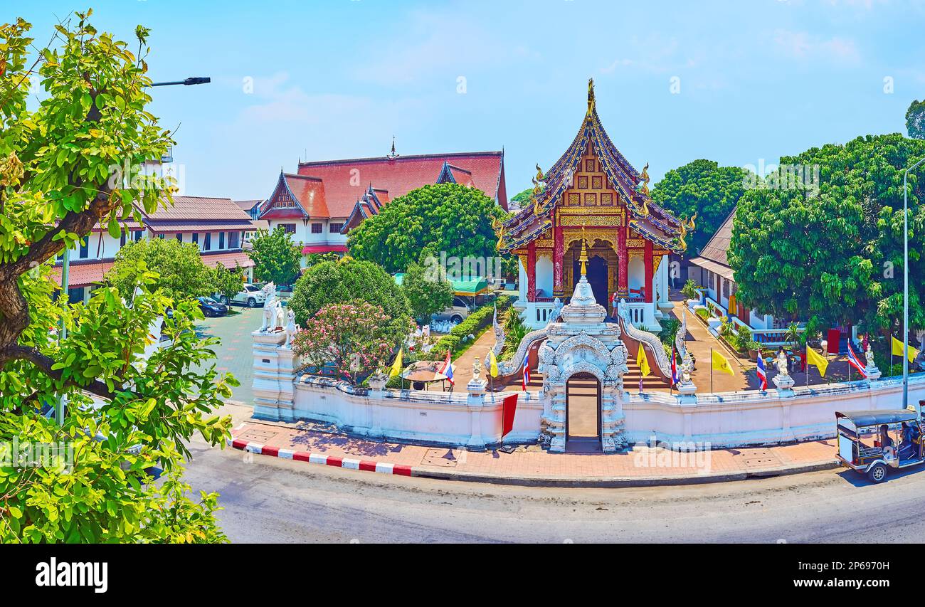 The top view of historic Wat Chang Taem with sculptured stucco gate and Viharn, decorated with Naga statues, pyathat roof, wooden pillars and gilt gab Stock Photo