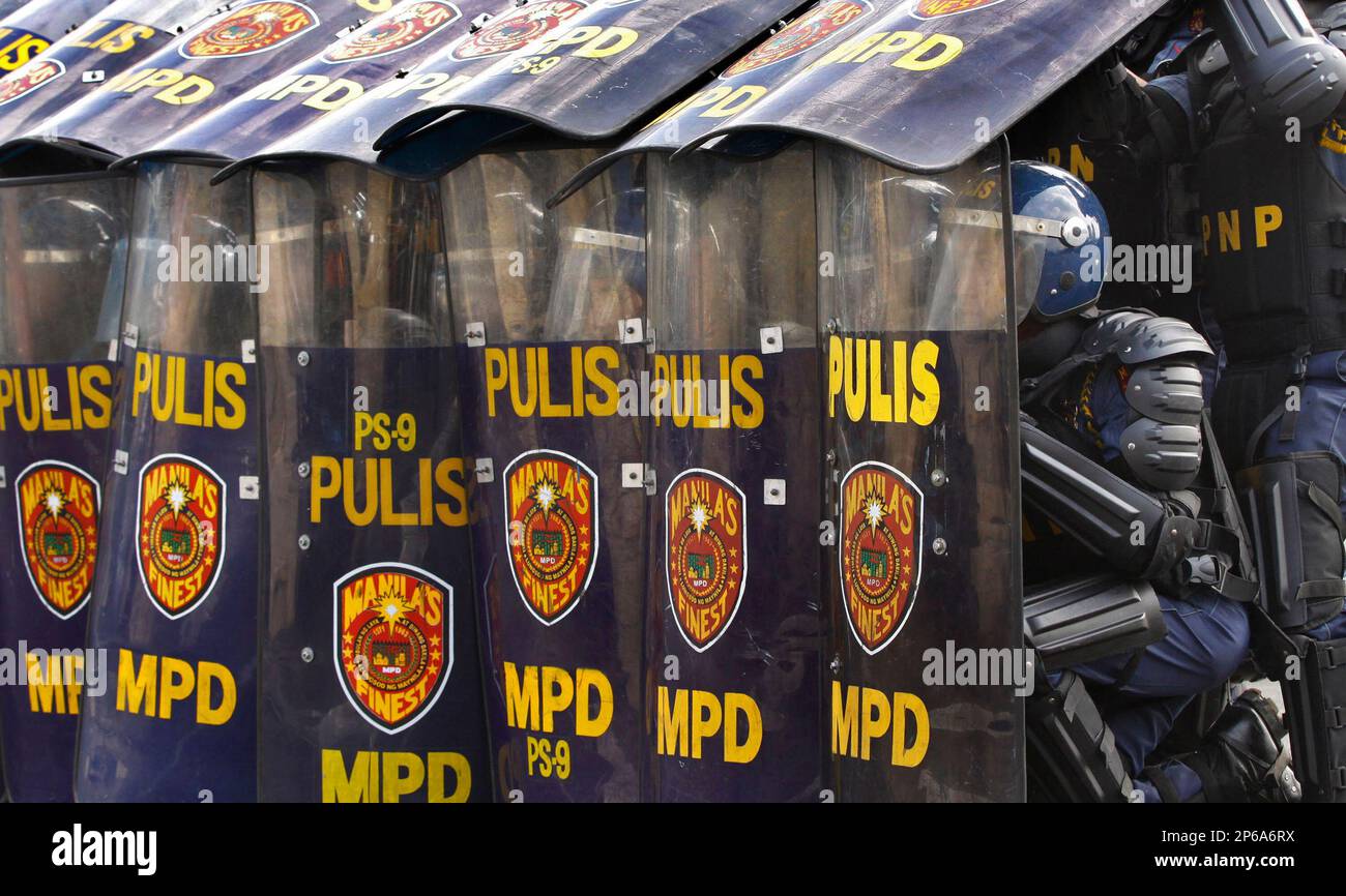 Anti Riot Unit Police Anti-riot police execute an umbrella formation as a protection against ...
