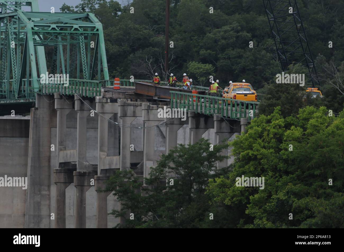A Jones Brothers Construction crew works around a steel bridge beam