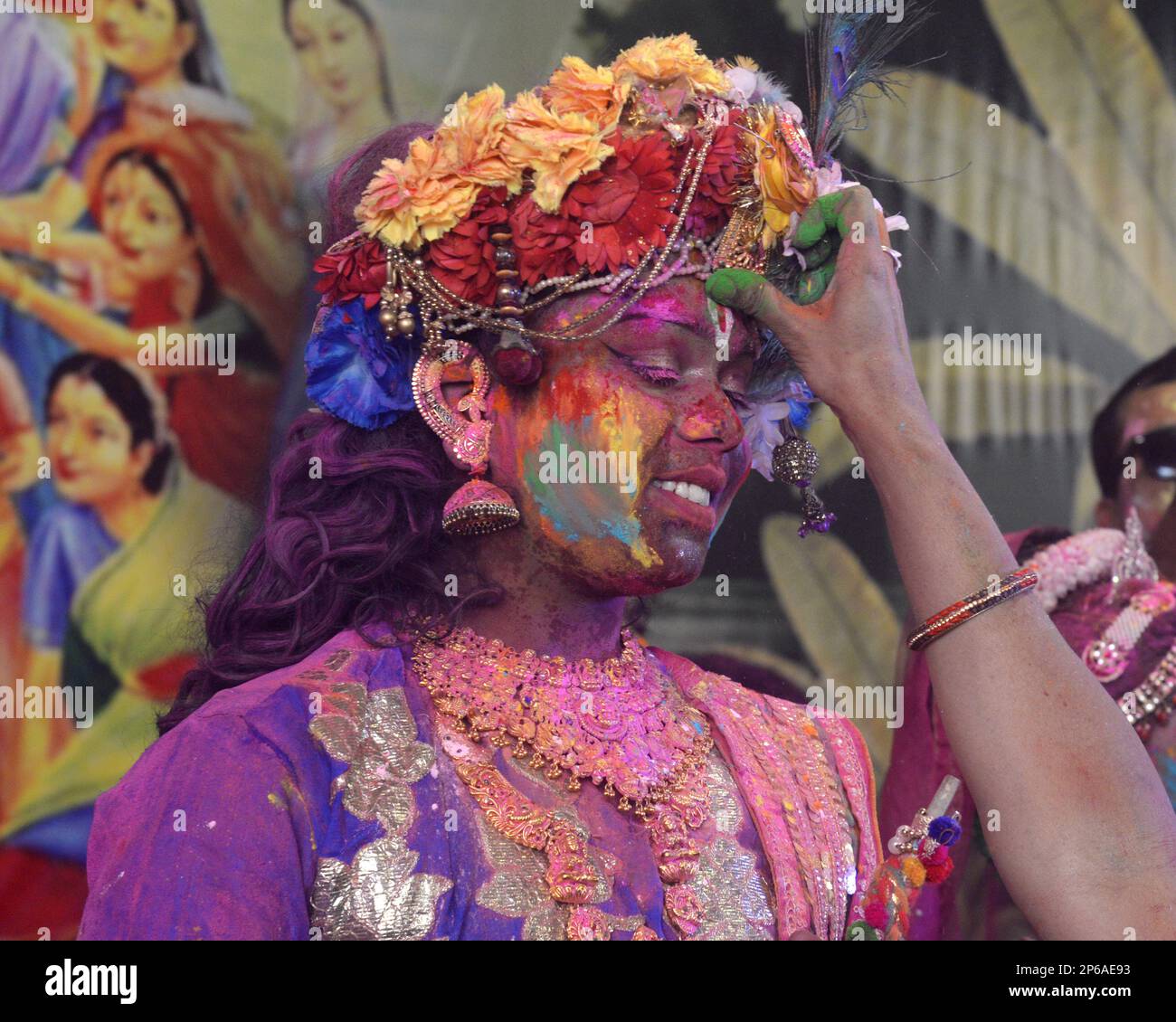 Kolkata India. 7th Mar 2023. People smear color to a devotee dressed in Lord Krishna attire during Holi Festival the festival of colors although it is also called Rangwali Holi or Dhulhendi