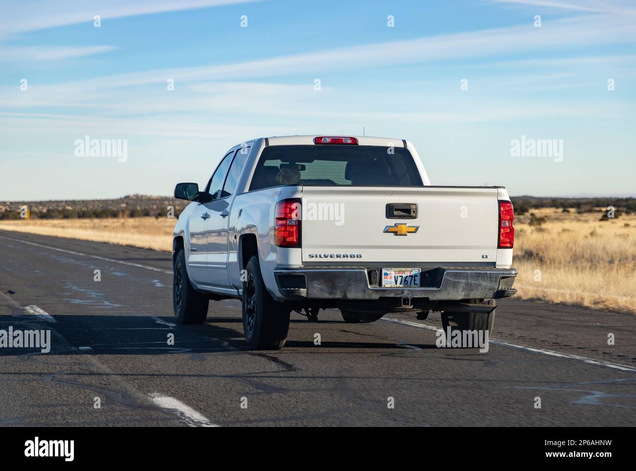 A picture of a white Chevrolet Silverado LT driving in Arizona. Stock Photo