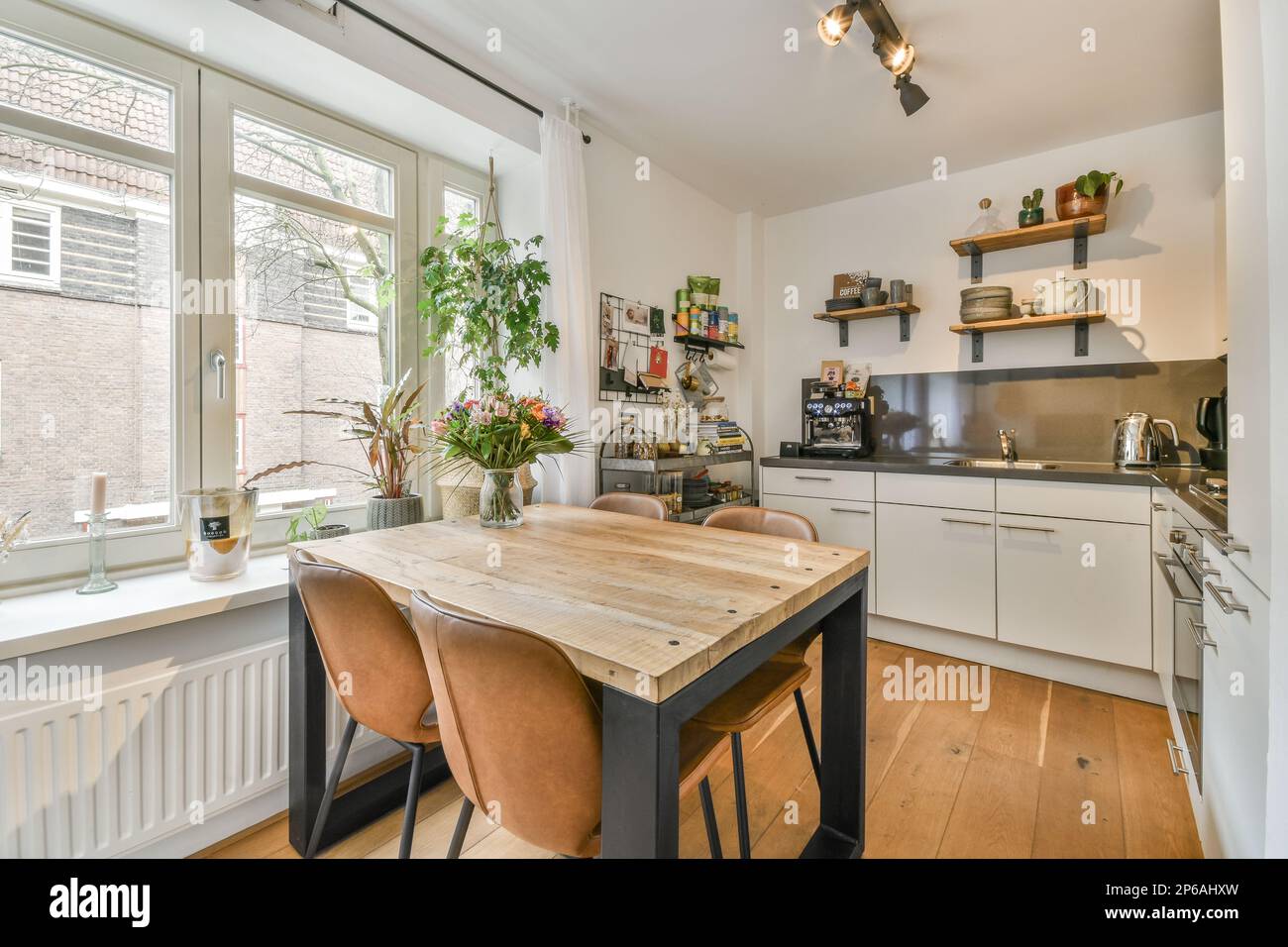 Picture of a kitchen and dining area in a small apartment with an open window to ...