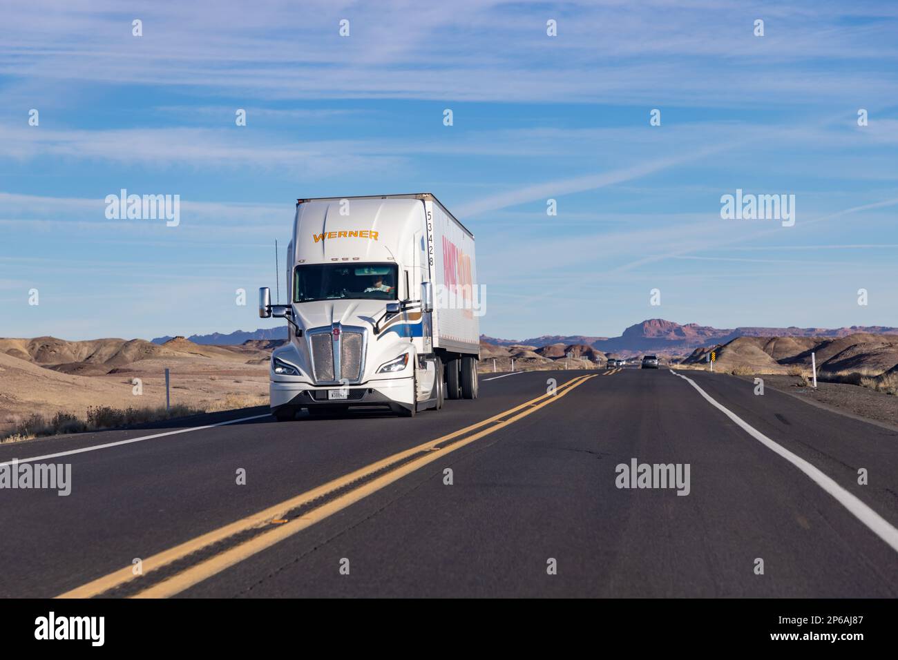A picture of a white Family Doller Kenworth truck driving in Arizona. Stock Photo