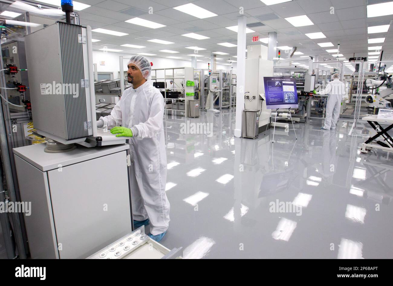 Senior Production Specialist William Yoshihara, left, works at a new