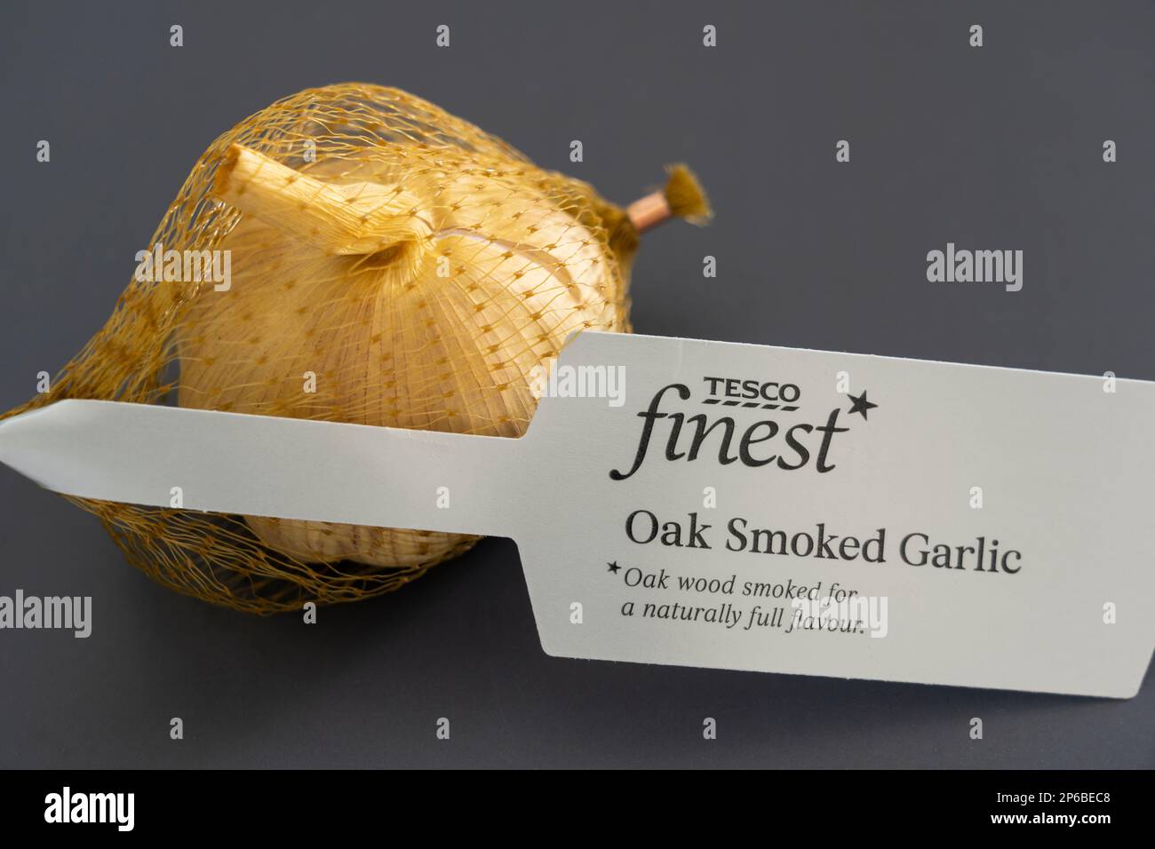 Tesco finest brand large oak smoked garlic bulb with a Tesco finest label, UK. Concept: premium range, Tesco Finest brand, Tesco Finest label Stock Photo