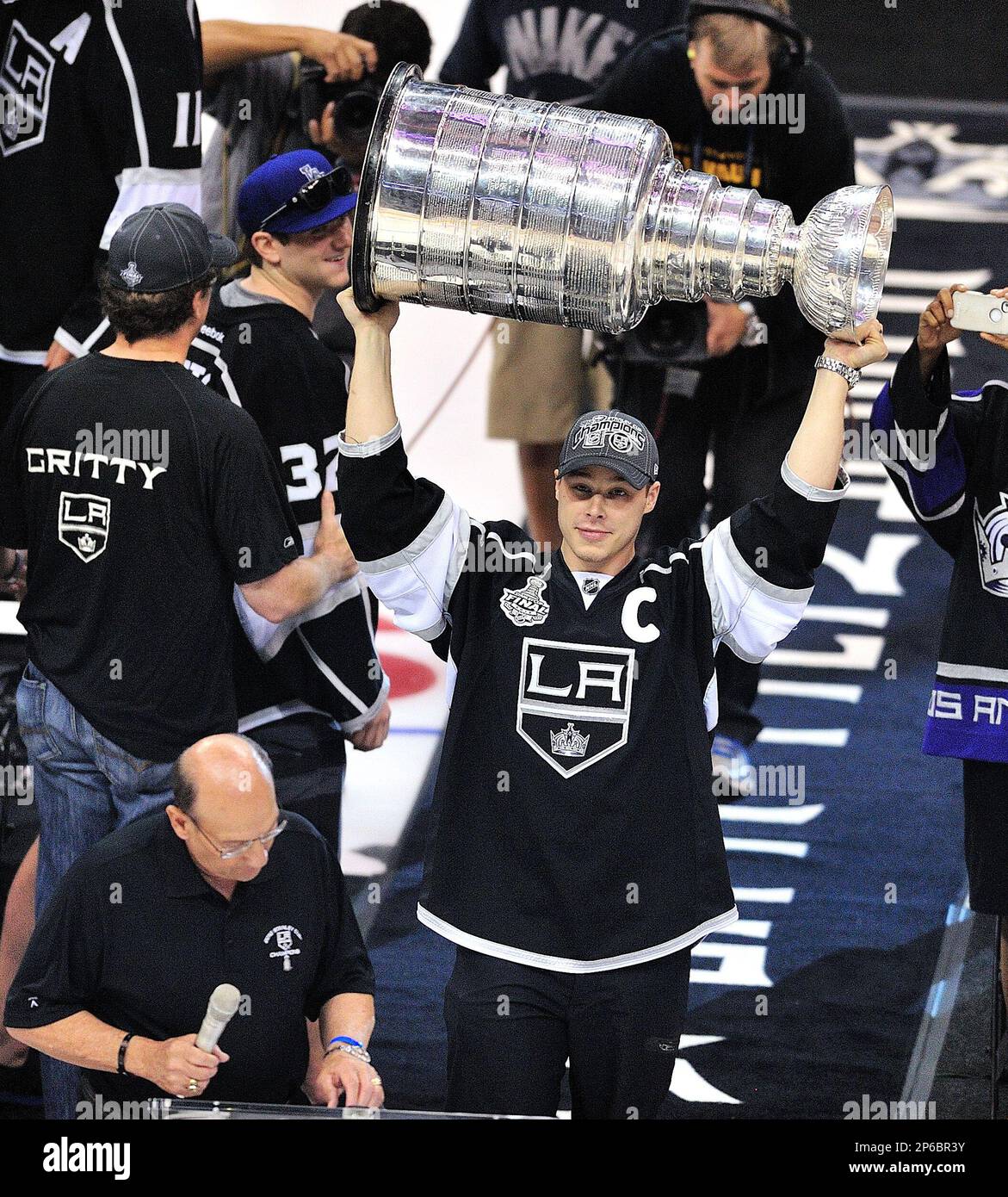 Dustin Brown holds up The Stanley Cup at an event where LA Kings