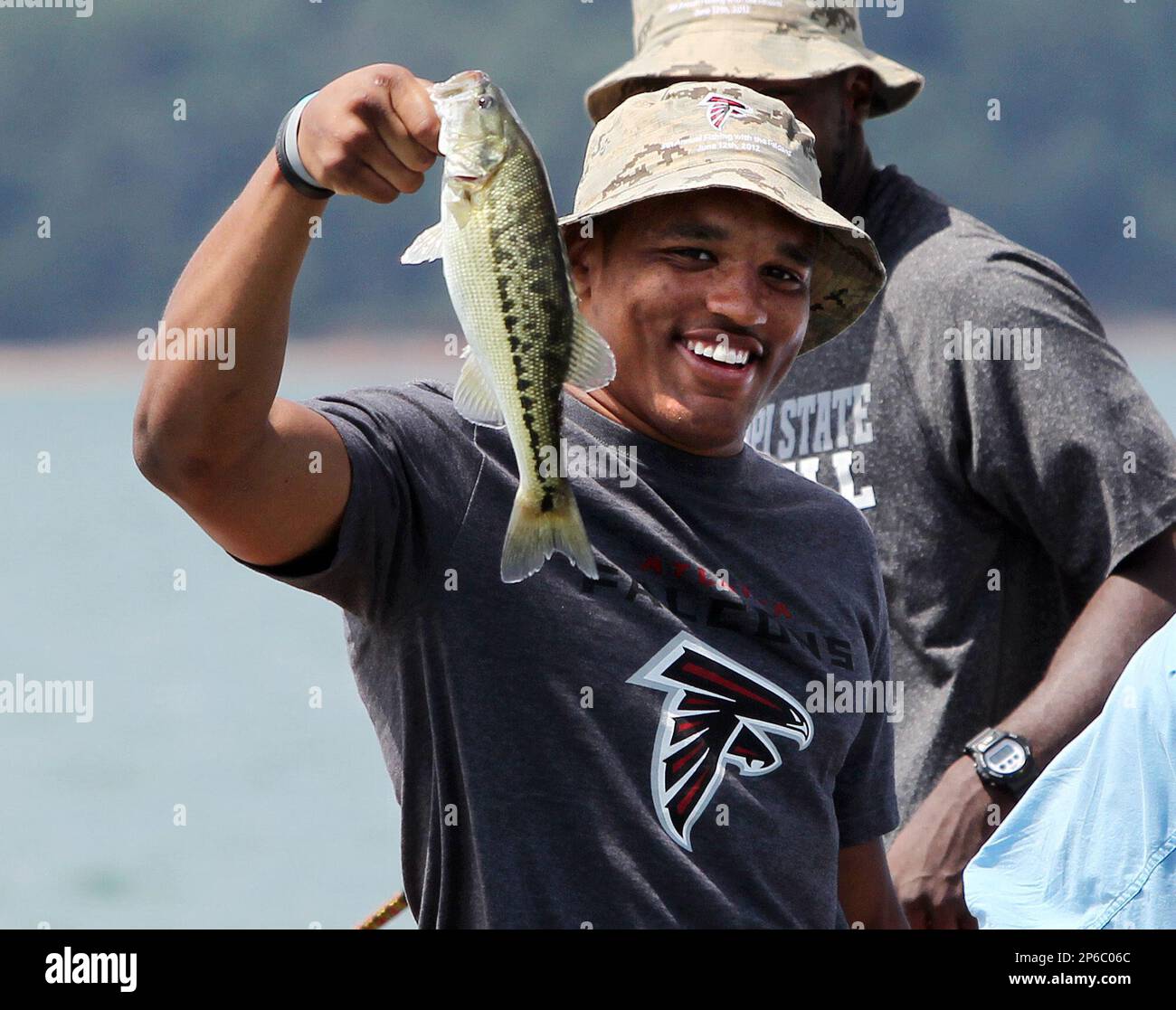 Atlanta Falcons rookie safety Chad Faulcon holds up a fish he